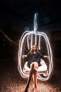 Woman sitting with light painting