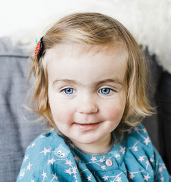 Close-up portrait of cute girl at home