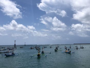 Boats in sea against sky