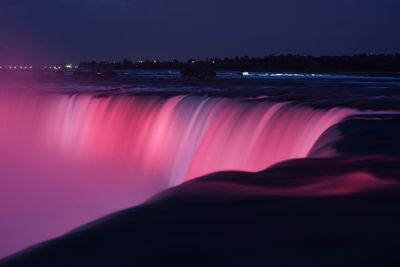 Scenic view of silhouette illuminated against sky at night