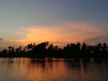 Scenic view of lake against orange sky