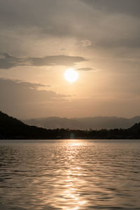 Scenic view of lake against sky during sunset