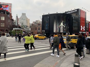 Group of people crossing road in city