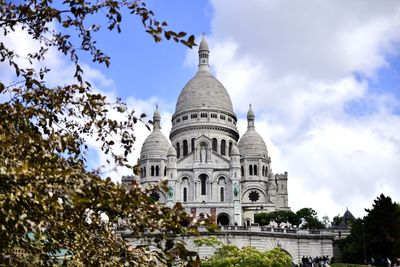 Low angle view of cathedral against cloudy sky