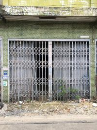 Closed metal fence against building