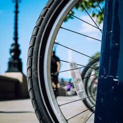 Close-up of bicycle wheel against sky