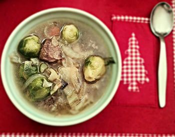 Directly above shot of beef soup served in bowl on table