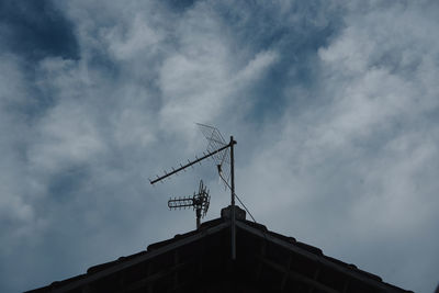 Low angle view of building against cloudy sky