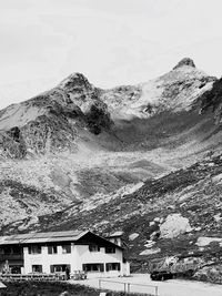 Houses on snowcapped mountain against sky