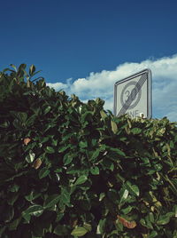 Low angle view of road sign against sky