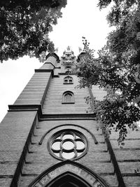 Low angle view of bell tower against sky