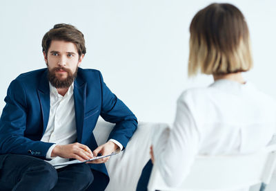 Young couple sitting in front of office