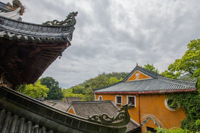 Low angle view of roof and building against sky