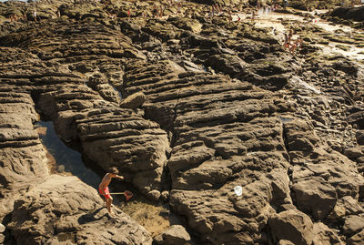 Rear view of person on rock