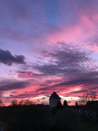 Silhouette house against sky during sunset