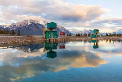 Scenic view of lake and buildings against sky