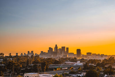 Buildings in city during sunset