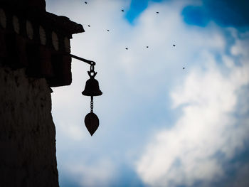 Low angle view of bird flying against sky