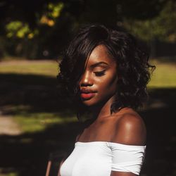 Close-up of beautiful young woman against blurred background