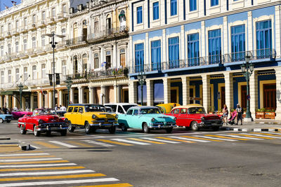 Traffic on city street by building