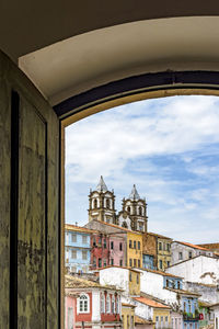 View of pelourinho neighborhood in the city of salvador through an old colonial style wooden window
