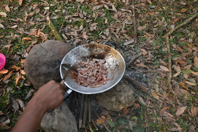 Cropped hand making food at campsite