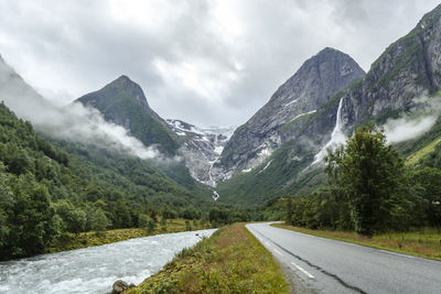 Road amidst mountains against sky