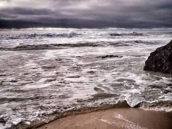 Scenic view of sea against cloudy sky