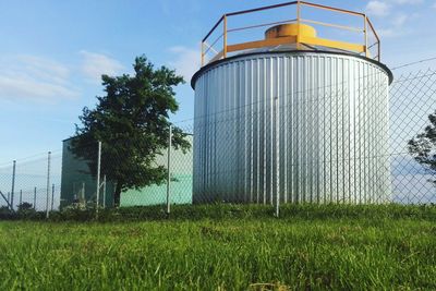 Built structure on field against sky