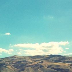 Scenic view of landscape against cloudy sky