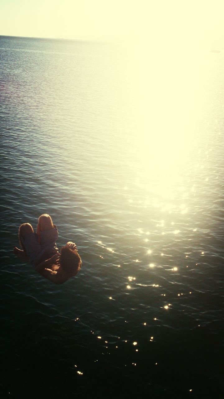 water, sea, tranquility, tranquil scene, beauty in nature, scenics, sunset, horizon over water, nature, rippled, reflection, waterfront, idyllic, sky, orange color, clear sky, no people, outdoors, high angle view, copy space