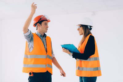 Architect discussing with colleague at site