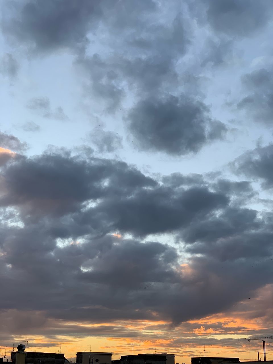 LOW ANGLE VIEW OF SUNLIGHT STREAMING THROUGH CLOUDS