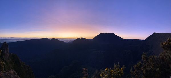 Scenic view of silhouette mountains against sky at sunset