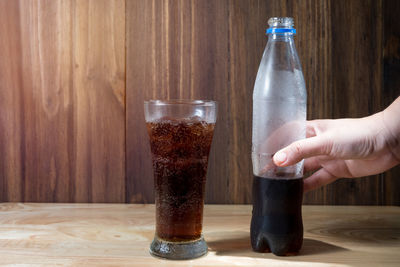 Hand holding glass of table