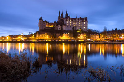 Reflection of illuminated buildings in water at night