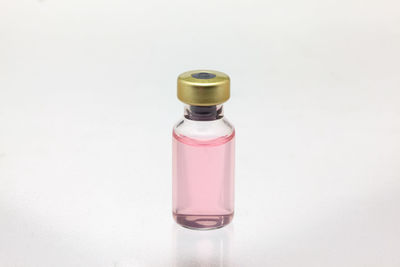 Close-up of glass bottle against white background