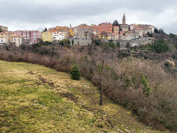 Buildings in city against sky
