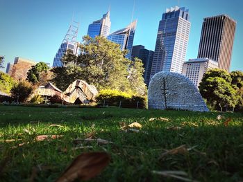Low angle view of trees and buildings against sky