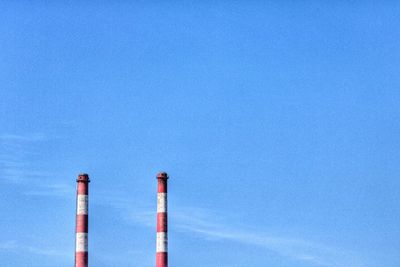 Low angle view of pole against blue sky