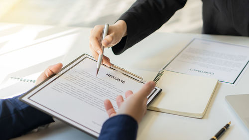 High angle view of woman reading book on table