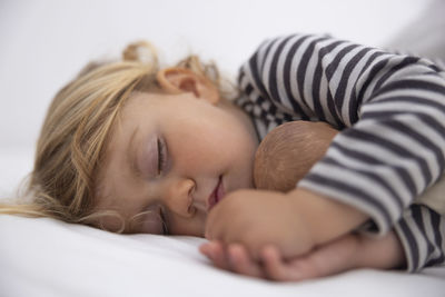 Close-up of baby sleeping on bed