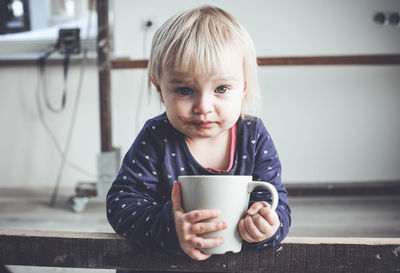 Portrait of girl drinking hot chocolate from mug