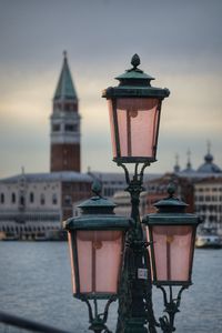 Street light in city against sky