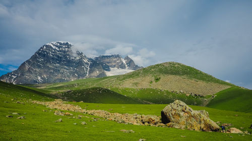 Scenic view of mountain against cloudy sky