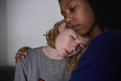 Young woman comforting crying friend