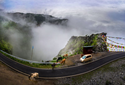 Panoramic shot of people on mountain against sky