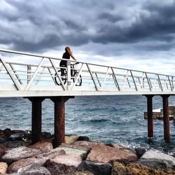 Silhouette of woman standing on pier