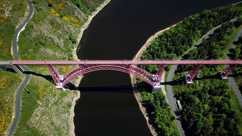 Bridge over river against trees