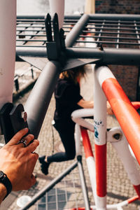 Close-up of person photographing camera on railing